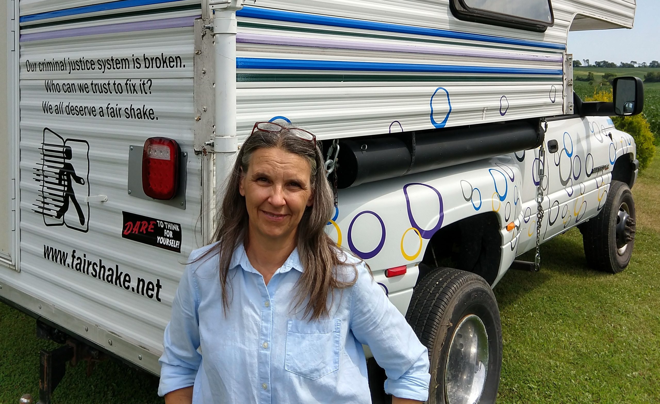 Sue K, Founder of Fair Shake in front of a Fair Shake truck